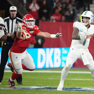Miami Dolphins quarterback Tua Tagovailoa (1) throws the ball under pressure from Kansas City Chiefs defensive end George Karlaftis (56) in the second half during an NFL International Series game at Deutsche Bank Park in Germany in 2023.