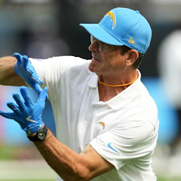 Aug 17, 2024; Inglewood, California, USA; Los Angeles Chargers coach Jim Harbaugh catches the ball during the game against th eLos Angeles Rams in the first half at SoFi Stadium. Mandatory Credit: Kirby Lee-Imagn Images