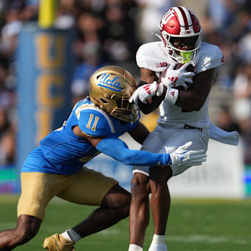 Indiana Hoosiers wide receiver Myles Price (4) catches the ball against UCLA Bruins defensive back Ramon Henderson (11) in the first half at Rose Bowl.