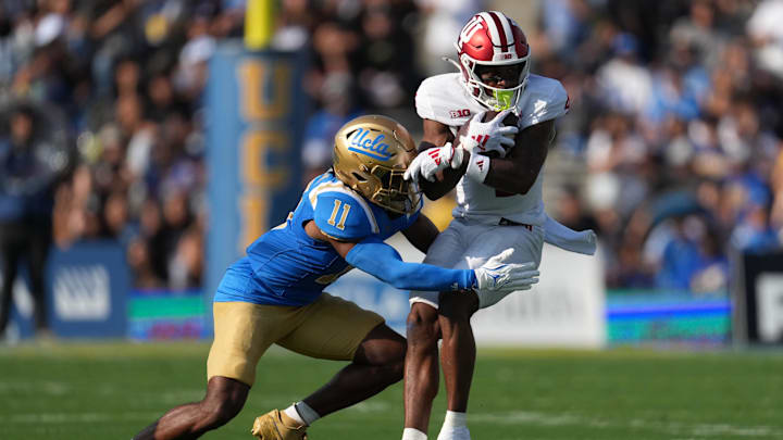 Indiana Hoosiers wide receiver Myles Price (4) catches the ball against UCLA Bruins defensive back Ramon Henderson (11) in the first half at Rose Bowl.