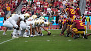 Nov 30, 2024; Los Angeles, California, USA; Helmets at the line of scrimmage as Notre Dame Fighting Irish long snapper Rino Monteforte (39) snaps the ball against the Southern California Trojans at United Airlines Field at Los Angeles Memorial Coliseum. 