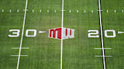 The Mountain West conference logo on the field at Allegiant Stadium. Mandatory Credit: Kirby Lee-Imagn Images
