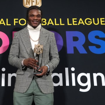 Feb 8, 2024; Las Vegas, NV, USA; Baltimore Ravens quarterback Lamar Jackson poses with the most valuable player trophy during the Pro Football Hall of Fame Class of 2024 press conference at the Resorts World Theatre. Mandatory Credit: Kirby Lee-USA TODAY Sports