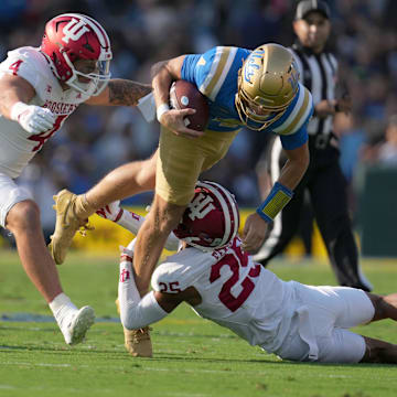 UCLA Bruins quarterback Ethan Garbers (4) is tackled by Indiana Hoosiers linebacker Aiden Fisher (4) and defensive back Amare Ferrell (25) in the first half at Rose Bowl.