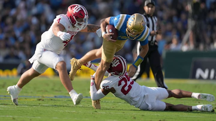 UCLA Bruins quarterback Ethan Garbers (4) is tackled by Indiana Hoosiers linebacker Aiden Fisher (4) and defensive back Amare Ferrell (25) in the first half at Rose Bowl.