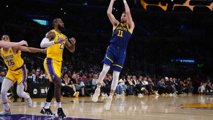Apr 9, 2024; Los Angeles, California, USA; Golden State Warriors guard Klay Thompson (11) shoots the ball against Los Angeles Lakers forward LeBron James (23) in the second half at Crypto.com Arena. Mandatory Credit: Kirby Lee-USA TODAY Sports