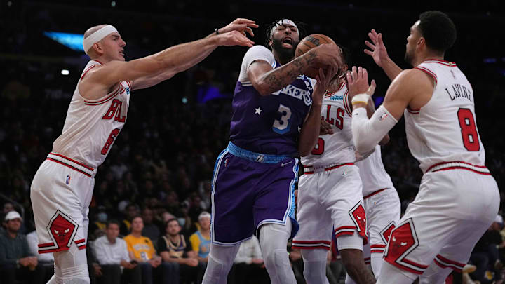 Los Angeles Lakers forward Anthony Davis (3) is defended by Chicago Bulls guard Alex Caruso (6), forward Derrick Jones Jr. (5) and guard Zach LaVine (8) in the first half at Staples Center. Mandatory Credit: Kirby Lee-Imagn Images