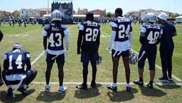 Dallas Cowboys safety Markquese Bell (14), linebacker Darius Harris (43), safety Malik Hooker (28), safety Israel Mukuamu (24), and cornerback Zion Childress (48) watch from the sidelines at training camp at the River Ridge Fields.