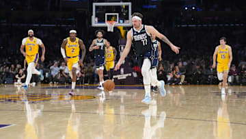 Jan 17, 2024; Los Angeles, California, USA; Dallas Mavericks guard Luka Doncic (77) dribbles the ball against the Los Angeles Lakers in the first half at Crypto.com Arena. Mandatory Credit: Kirby Lee-Imagn Images