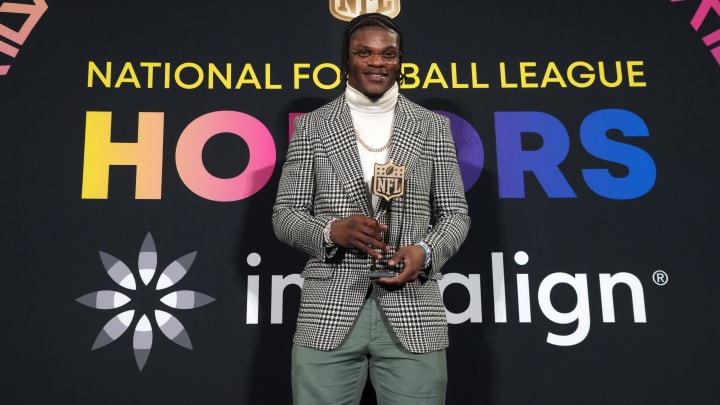 Feb 8, 2024; Las Vegas, NV, USA; Baltimore Ravens quarterback Lamar Jackson poses with the most valuable player trophy during the Pro Football Hall of Fame Class of 2024 press conference at the Resorts World Theatre. Mandatory Credit: Kirby Lee-USA TODAY Sports