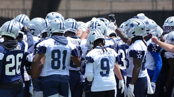 Dallas Cowboys players huddle during training camp at the River Ridge Fields.