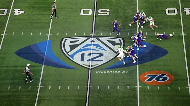 Dec 1, 2023; Las Vegas, NV, USA; A general overall view as Washington Huskies quarterback Michael Penix Jr. (9)] throws the ball at midfield on the Pac-12 Conference logo against the Oregon Ducks in the first half at Allegiant Stadium. Mandatory Credit: Kirby Lee-Imagn Images