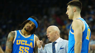 Mar 8, 2025; Los Angeles, California, USA; UCLA Bruins head coach Mick Cronin (center) talks with guard Skyy Clark (55) and guard Lazar Stefanovic (10) in the second half against the Southern California Trojans at Pauley Pavilion presented by Wescom. Mandatory Credit: Kirby Lee-Imagn Images