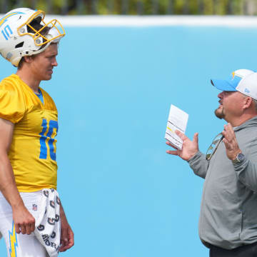 Jun 13, 2024; Costa Mesa, CA, USA; Los Angeles Chargers quarterback Justin Herbert (10) interacts with offensive coordinator Greg Roman during minicamp at the Hoag Performance Center.  Mandatory Credit: Kirby Lee-USA TODAY Sports