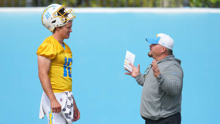 Jun 13, 2024; Costa Mesa, CA, USA; Los Angeles Chargers quarterback Justin Herbert (10) interacts with offensive coordinator Greg Roman during minicamp at the Hoag Performance Center.  Mandatory Credit: Kirby Lee-USA TODAY Sports