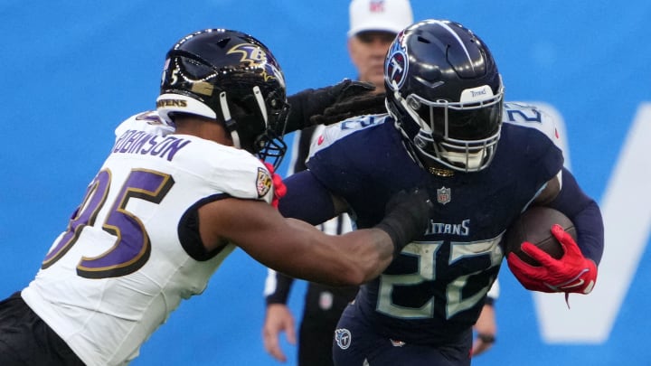 Oct 15, 2023; London, United Kingdom; Tennessee Titans running back Derrick Henry (22) carries the ball against Baltimore Ravens linebacker Tavius Robinson (95) in the second half during an NFL International Series game at Tottenham Hotspur Stadium. Mandatory Credit: Kirby Lee-USA TODAY Sports