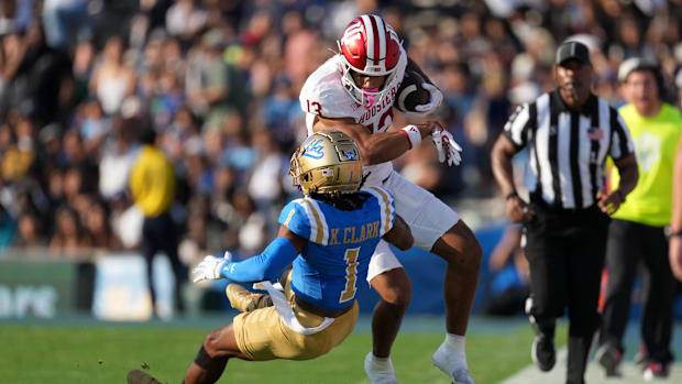 Indiana Hoosiers wide receiver Elijah Sarratt (13) carries the ball against UCLA Bruins defensive back Kanye Clark (1) in the