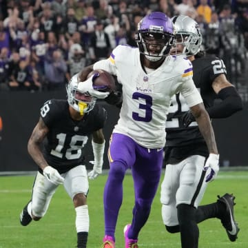 Dec 10, 2023; Paradise, Nevada, USA; Minnesota Vikings wide receiver Jordan Addison (3) carries the ball against Las Vegas Raiders cornerback Jack Jones (18) in the second half at Allegiant Stadium.