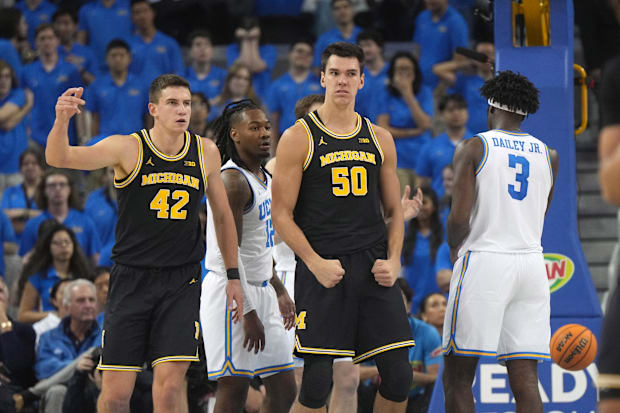 Michigan Wolverines center Vladislav Goldin (50) and forward Will Tschetter (42) react against the UCLA Bruins.