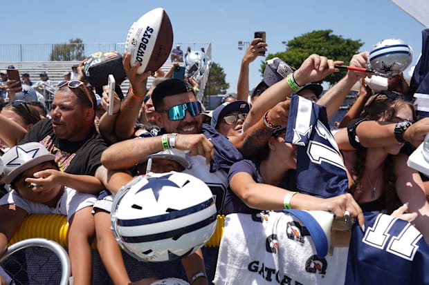 Dallas Cowboys fans ask for autographs during training camp at the River Ridge Fields. 