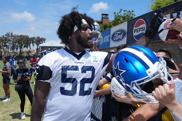 Dallas Cowboys guard Tyler Booker signs autographs during training camp at the River Ridge Fields. Dallas Cowboys guard Tyler Booker signs autographs during training camp at the River Ridge Fields.