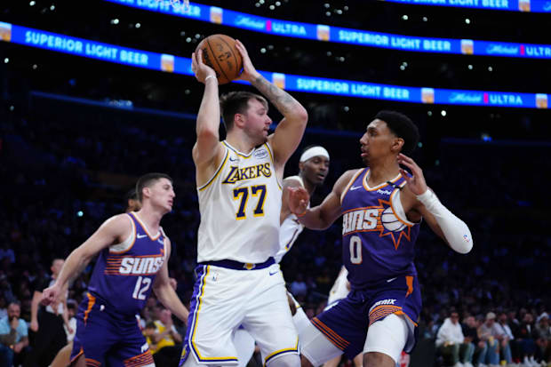 Los Angeles Lakers guard Luka Doncic (77) is defended by Phoenix Suns forward Ryan Dunn (0) in the second half at Crypto.com 