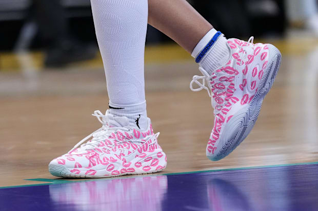 Angel Reese's pink and white Reebok sneakers.