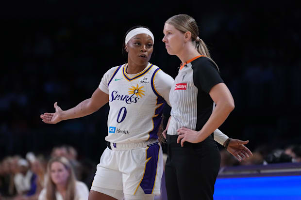 LA Sparks guard Odyssey Sims talks with referee Jenna Reneau. 