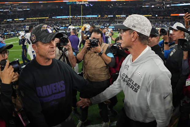 Baltimore Ravens coach John Harbaugh (left) beat his brother, Chargers coch Jim Harbaugh, on Monday night.