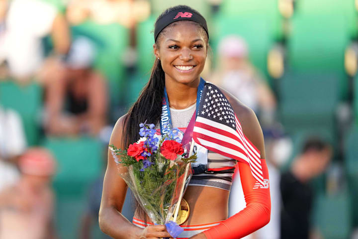 Gabby Thomas poses with gold medal after winning the women's 200m in a meet-record 21.61 during the US Olympic Team Trials.