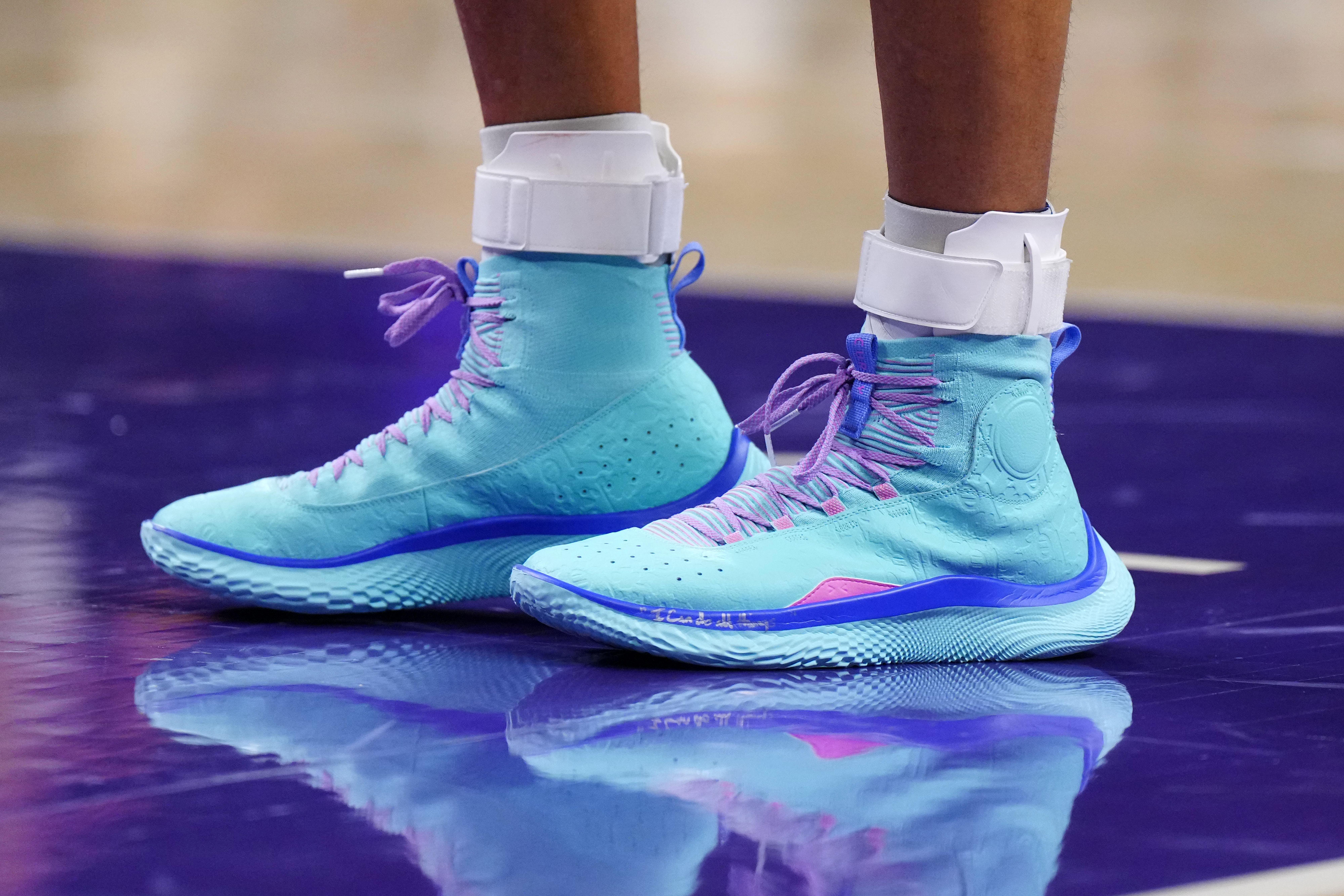 Golden State Warriors guard Stephen Curry's teal and purple sneakers.