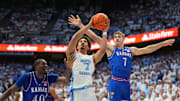 Nov 7, 2025; Chapel Hill, North Carolina, USA;  North Carolina Tar Heels guard Seth Trimble (7) shoots as Kansas Jayhawks forward Flory Bidunga (40) and guard Kohl Rosario (7) defend in the second half at Dean E. Smith Center. Mandatory Credit: Bob Donnan-Imagn Images