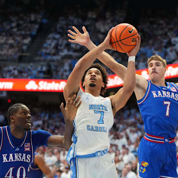 Nov 7, 2025; Chapel Hill, North Carolina, USA;  North Carolina Tar Heels guard Seth Trimble (7) shoots as Kansas Jayhawks forward Flory Bidunga (40) and guard Kohl Rosario (7) defend in the second half at Dean E. Smith Center. Mandatory Credit: Bob Donnan-Imagn Images