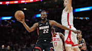 Mar 21, 2025; Miami, Florida, USA;  Miami Heat forward Andrew Wiggins (22) grabs a rebound as Houston Rockets center Alperen Sengun (28) looks on in the second half at Kaseya Center. Mandatory Credit: Jim Rassol-Imagn Images