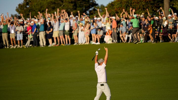 Bryson DeChambeau reacts after draining a shot from the fairway to finish the 18th hole at Augusta National.