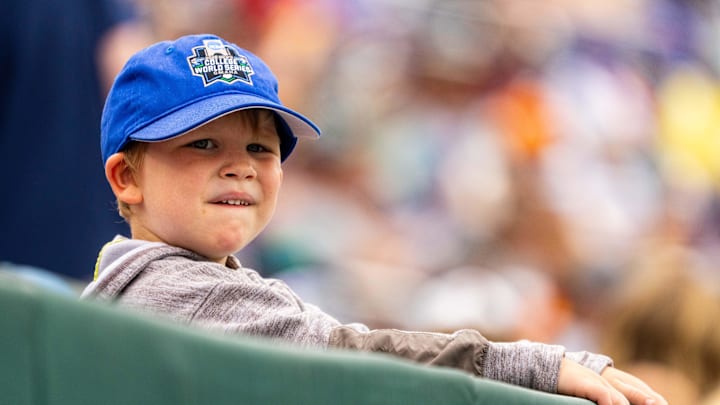 Jun 19, 2024; Omaha, NE, USA; A young fan watches from the stands during the sixth inning between the Kentucky Wildcats and the Florida Gators at Charles Schwab Field Omaha. Mandatory Credit: Dylan Widger-Imagn Images