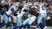 Dallas Cowboys defensive end Donovan Ezeiruaku and defensive end Sam Williams tackle Las Vegas Raiders running back Ashton Jeanty