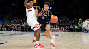 Mar 12, 2025; Charlotte, NC, USA; California Golden Bears guard Andrej Stojakovic (2) with the ball as Stanford Cardinal guard Jaylen Blakes (21) defends in the second half at Spectrum Center. Mandatory Credit: Bob Donnan-Imagn Images
