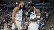 Jan 11, 2025; Minneapolis, Minnesota, USA; Minnesota Timberwolves guard Anthony Edwards (5) celebrates after making a shot and a foul is called as center Rudy Gobert (27) looks on against the Memphis Grizzlies at Target Center. Mandatory Credit: Jesse Johnson-Imagn Images
