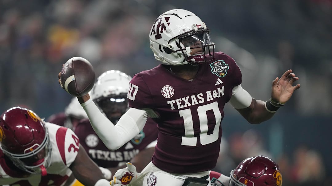 Dec 27, 2024; Las Vegas, NV, USA; Texas A&M Aggies quarterback Marcel Reed (10) throws the ball against Southern California Trojans cornerback John Humphrey (19) in the first half at Allegiant Stadium. Mandatory Credit: Kirby Lee-Imagn Images