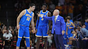 Jan 27, 2025; Los Angeles, California, USA; UCLA Bruins head coach Mick Cronin talks with guard Lazar Stefanovic (10) and guard Eric Dailey Jr. (3) against the Southern California Trojans at the Galen Center. Mandatory Credit: Kirby Lee-Imagn Images