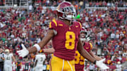 Nov 30, 2024; Los Angeles, California, USA; Southern California Trojans wide receiver Ja'Kobi Lane (8) celebrates after scoring on a 6-yard touchdown reception against the Notre Dame Fighting Irish in the second half at United Airlines Field at Los Angeles Memorial Coliseum. Mandatory Credit: Kirby Lee-Imagn Images