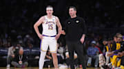 Dec 15, 2024; Los Angeles, California, USA; Los Angeles Lakers coach JJ Redick (right) talks with guard Austin Reaves (15) in the first half at Crypto.com Arena. Mandatory Credit: Kirby Lee-Imagn Images