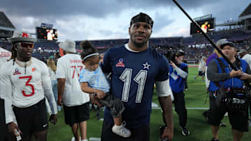 Feb 2, 2025; Orlando, FL, USA; NFC defensive end Micah Parson of the Dallas Cowboys (11) holds his daughter Shatara Parsons after the 2025 Pro Bowl Games at Camping World Stadium. Mandatory Credit: Kirby Lee-Imagn Images