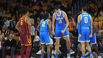 UCLA Bruins center Aday Mara celebrates with guard Dylan Andrews and guard Kobe Johnson as Southern California Trojans guard Wesley Yates III watches.