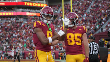Nov 30, 2024; Los Angeles, California, USA; Southern California Trojans wide receiver Ja'Kobi Lane (8) celebrates with tight end Walker Lyons (85) after scoring on a 6-yard touchdown reception against the Notre Dame Fighting Irish in the second half at United Airlines Field at Los Angeles Memorial Coliseum. Mandatory Credit: Kirby Lee-Imagn Images