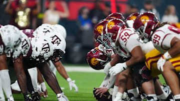 Dec 27, 2024; Las Vegas, NV, USA; Helmets at the line fo scrimmage as DUPLICATE***Southern California Trojans long snapper Hank Pepper (31) snaps the ball against the Texas A&M Aggies at Allegiant Stadium. Mandatory Credit: Kirby Lee-Imagn Images