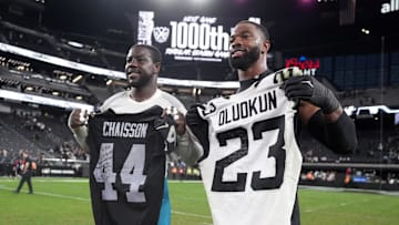 Dec 22, 2024; Paradise, Nevada, USA; Jacksonville Jaguars linebacker Foyesade Oluokun (left) and Las Vegas Raiders defensive end K'Lavon Chaisson pose after exchanging jerseys after the game at Allegiant Stadium. 