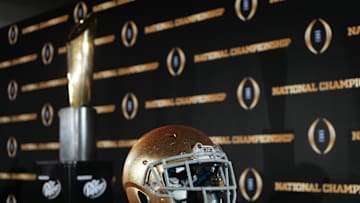 Jan 19, 2025; Atlanta, GA, USA; A Notre Dame Fighting Irish helmet and College Football Playoff National Championship trophy at press conference at The Westin Peachtree Plaza, Savannah Ballroom. Mandatory Credit: Kirby Lee-Imagn Images