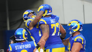 Dec 8, 2024; Inglewood, California, USA; Los Angeles Rams running back Kyren Williams (23) celebrates with quarterback Matthew Stafford (9) and offensive tackle Alaric Jackson (77) after scoring in a 7-yard touchdown run against the Buffalo Bills in the third quarter at SoFi Stadium. Mandatory Credit: Kirby Lee-Imagn Images